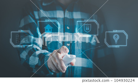 Man with remote control on smart home applications, concept of digitalization. Man with remote control on smart home applications, concept of digitalization. 104930224
