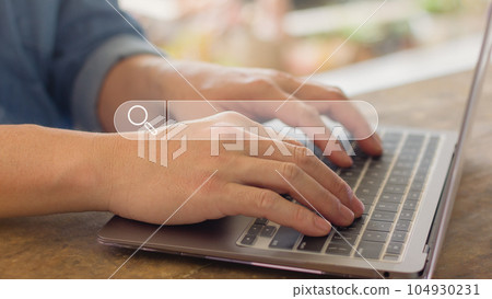 Man hand typing on laptop to searching information in search engine toolbox 104930231
