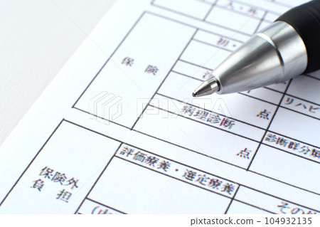 Medical bill and ballpoint pen 104932135