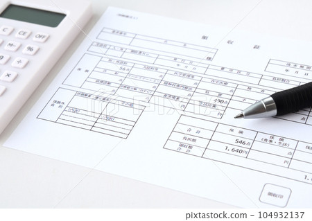 Medical bill and ballpoint pen 104932137