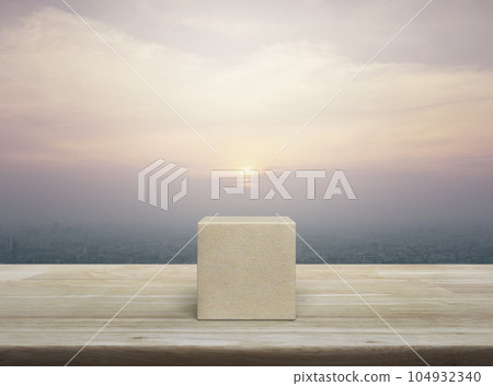 Wood block cube on wooden table 104932340