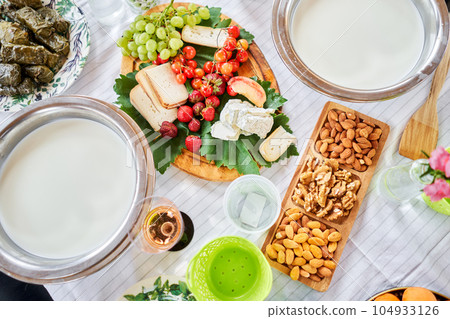 Making cheese from goat milk at home. Female and stir cheese sourdough with a spoon in a saucepan. Technology of cooking cheese. Cheese-making processes. Cooking concept 104933126
