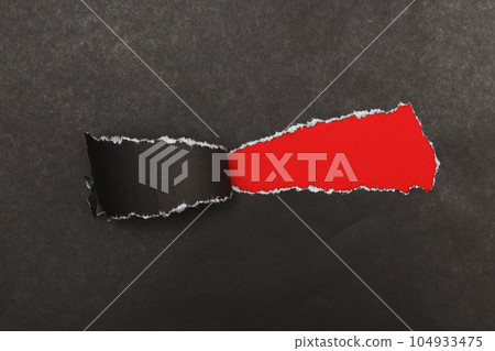 curl of torn black paper on red background. advertising and sale concept. copy space curl of torn black paper on red background. advertising and sale concept. copy space 104933475