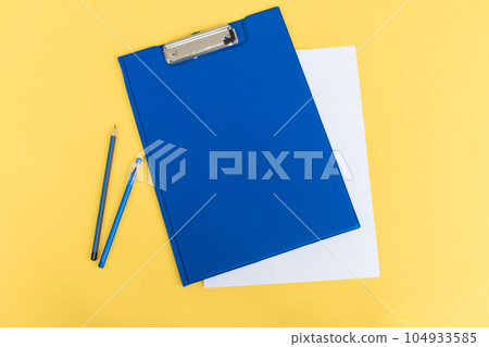 A set of blue stationery as a template with a place to copy on a yellow background, pen and pencil A set of blue stationery as a template with a place to copy on a yellow background, pen and pencil 104933585