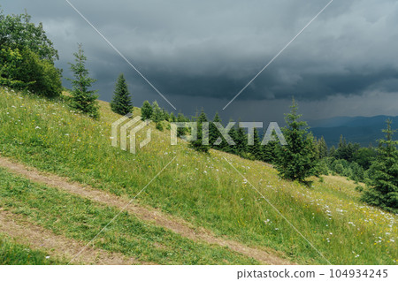 Green Ukrainian mountains in front of the storm. Summer time. Beautiful view of the largest peaks. 104934245