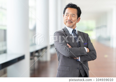 Manager middle-aged businessman working in the office Manager middle-aged businessman working in the office 104939010