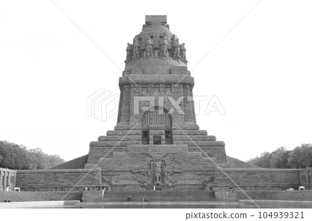 Monument to the Battle of the Nations in Leipzig, Germany against a cloudy sky in grayscale Monument to the Battle of the Nations in Leipzig, Germany against a cloudy sky in grayscale 104939321