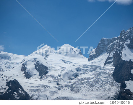 Zermatt, Switzerland - July 1st: Panoramic view towards two peaks above 4000 Meter: Castor and Pollux Zermatt, Switzerland - July 1st: Panoramic view towards two peaks above 4000 Meter: Castor and Pollux 104940046
