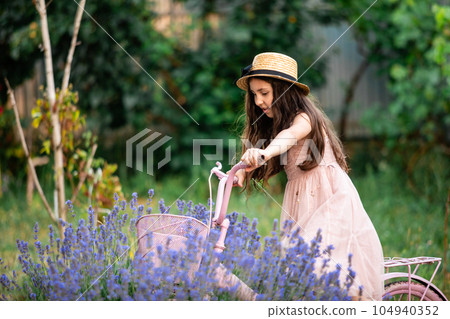 Beautiful long hair girl near lavender bushes 104940352