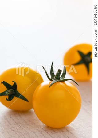 Orange mini tomatoes on a white plate 104940360