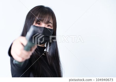 A woman holding a model gun 104940673
