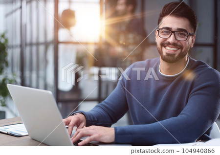 Businessman working on a laptop computer in the office 104940866