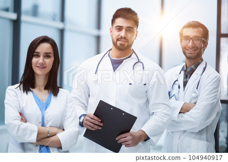 Portrait of three confident doctors in the hospital corridor 104940917