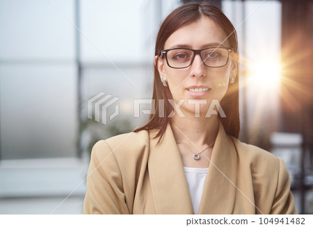 Portrait of a young beautiful business woman in the office Portrait of a young beautiful business woman in the office 104941482