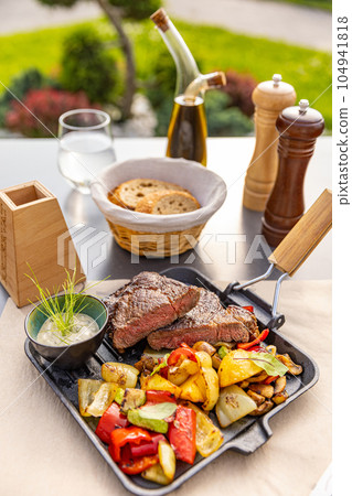 Grilled pork chops with roasted vegetables Grilled pork chops with roasted vegetables 104941818