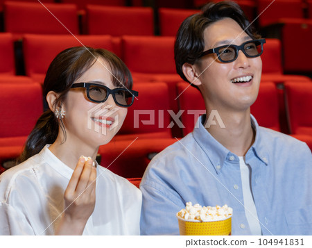 Young couple watching 3D movie 104941831