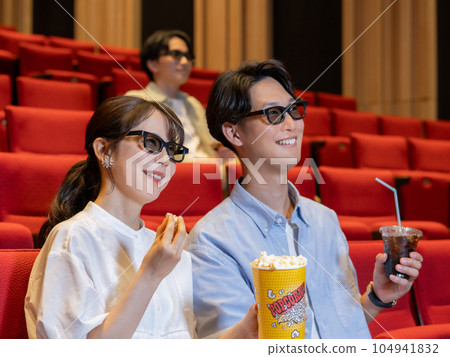 Young couple watching 3D movie 104941832