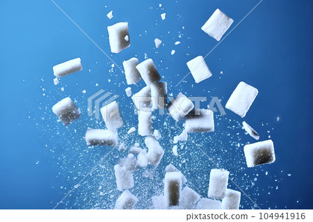 Sugar cubes, lumps of sugar, lumps of sugar and lumps of sugar fly up and to all sides against a blue background, made with generative ai 104941916