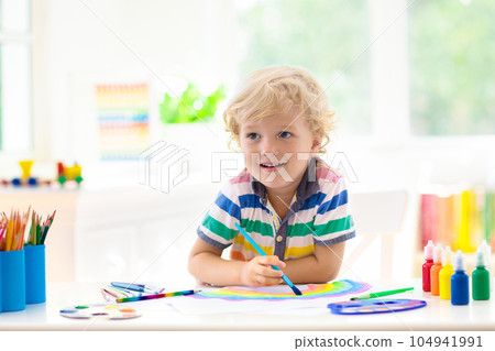 Kids paint. Child painting. Little boy drawing. 104941991