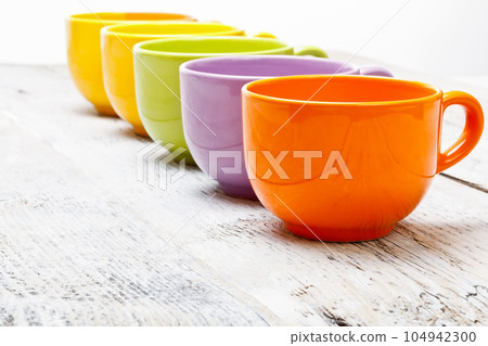 Row of color tea cups 104942300