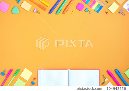 Frame of colorful school and office stationery set on yellow background. Flatly. 104942556