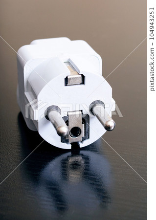 Socket adapter on a wooden table closeup 104943251