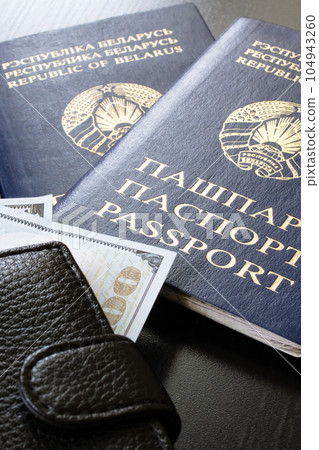 Belarusian passport and money dollars on wooden table Belarusian passport and money dollars on wooden table 104943260