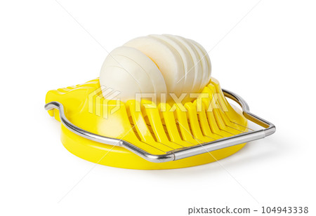 Boiled egg in the egg slicer. 104943338