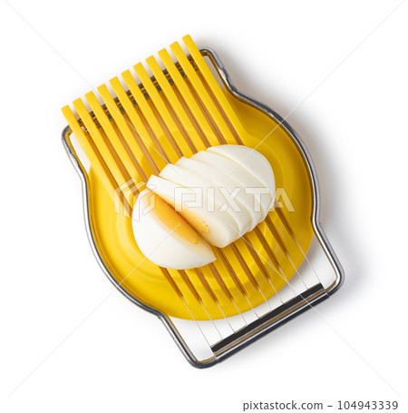 Boiled egg in the egg slicer. 104943339