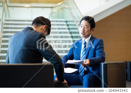 Middle businessman scolding business partners Middle businessman scolding business partners 104943341