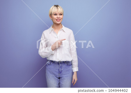 young smart blonde secretary woman dressed in a white shirt points her finger at the stone with young smart blonde secretary woman dressed in a white shirt points her finger at the stone with 104944402