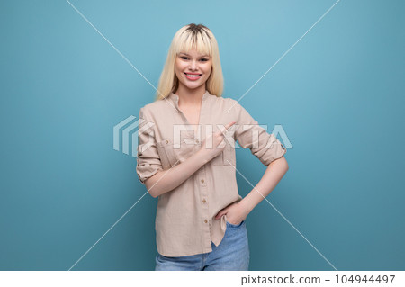 portrait of surprised pretty blonde european young woman pointing finger to the side at the news portrait of surprised pretty blonde european young woman pointing finger to the side at the news 104944497