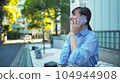 Image of talking on a smartphone outdoors 104944908