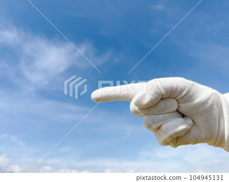 White glove index finger _ sideways _ blue sky background 104945131