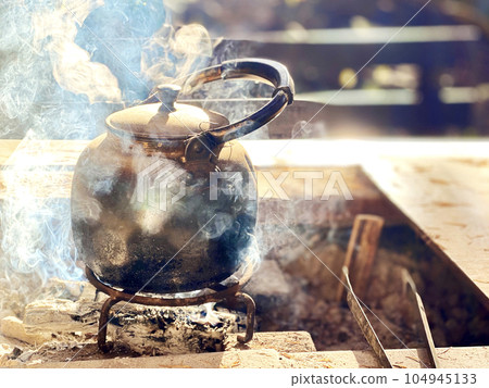 Kettle with steam outdoors Kettle with steam outdoors 104945133