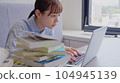 A woman who works while watching materials 104945139