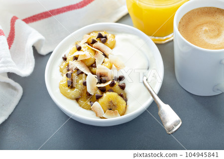 Plain yogurt with bananas, chocolate and coconut Plain yogurt with bananas, chocolate and coconut 104945841