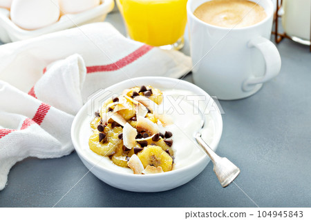 Plain yogurt with bananas, chocolate and coconut 104945843