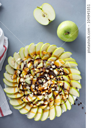 White and dark chocolate chip apple nachos White and dark chocolate chip apple nachos 104945851