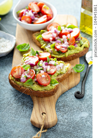 Fresh guacamole and tomato sandwich spread 104945861