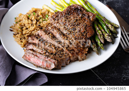 Delisious steak with rice and asparagus 104945865