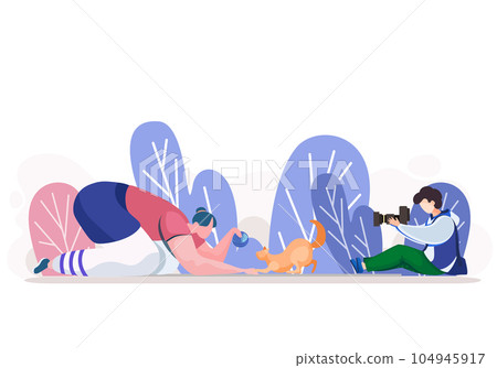 Outdoor photo session of the cat. Woman playing with her red kitten, while man takes photo 104945917