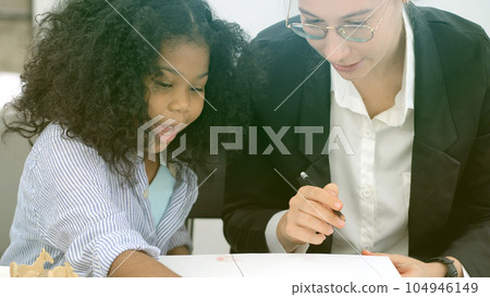 Creative class in diversity school Caucasian teacher with African kid having fun learning critical thinking global citizen education concept 104946149