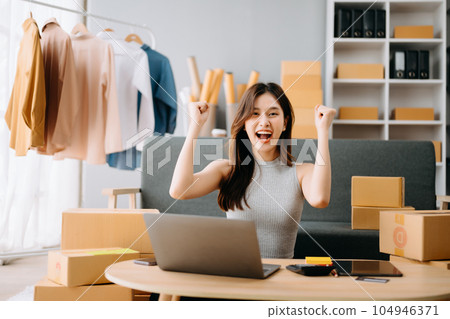 Startup small business SME, Entrepreneur owner woman using smartphone or tablet taking receive and checking online purchase shopping order to preparing pack product box. . Startup small business SME, Entrepreneur owner woman using smartphone or tablet taking receive and checking online purchase shopping order to preparing pack product box. . 104946371