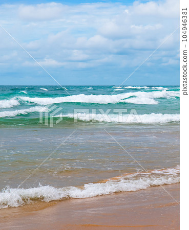 A tropical beach with high waves. Vertical photo. 104946381