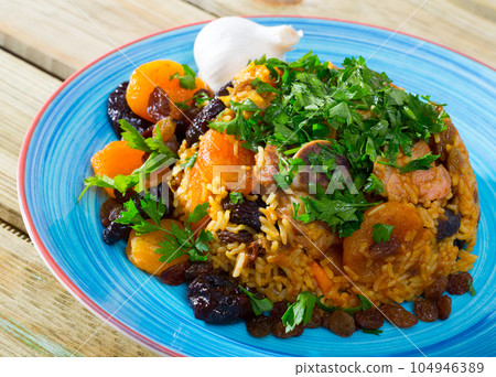 Rice pilaf with mutton, prunes, garlic Rice pilaf with mutton, prunes, garlic 104946389