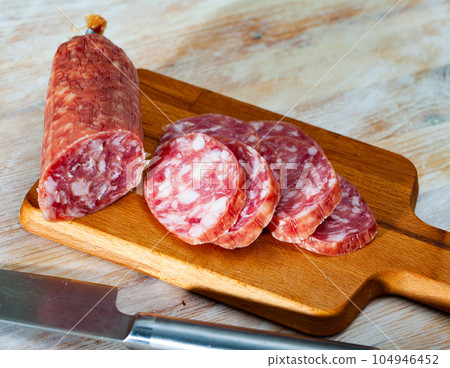 Spanish dry cured pork sausage Salchichon 104946452