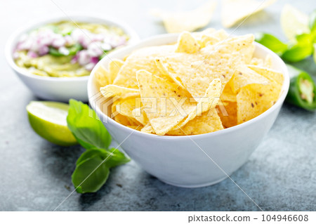 Corn chips with guacamole Corn chips with guacamole 104946608
