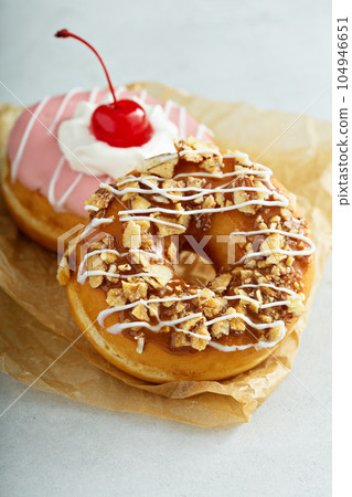 Sweet caramel and cherry glazed donuts Sweet caramel and cherry glazed donuts 104946651
