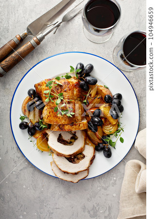 Roasted pork loin stuffed with apple and cranberry Roasted pork loin stuffed with apple and cranberry 104946659